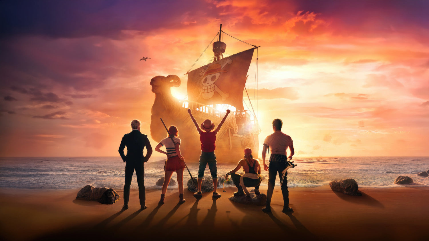 The crew of the Straw Hat Pirates, including Monkey D. Luffy with his arms raised, stand on a beach looking out at their pirate ship, the Going Merry, against a vibrant golden sunset.